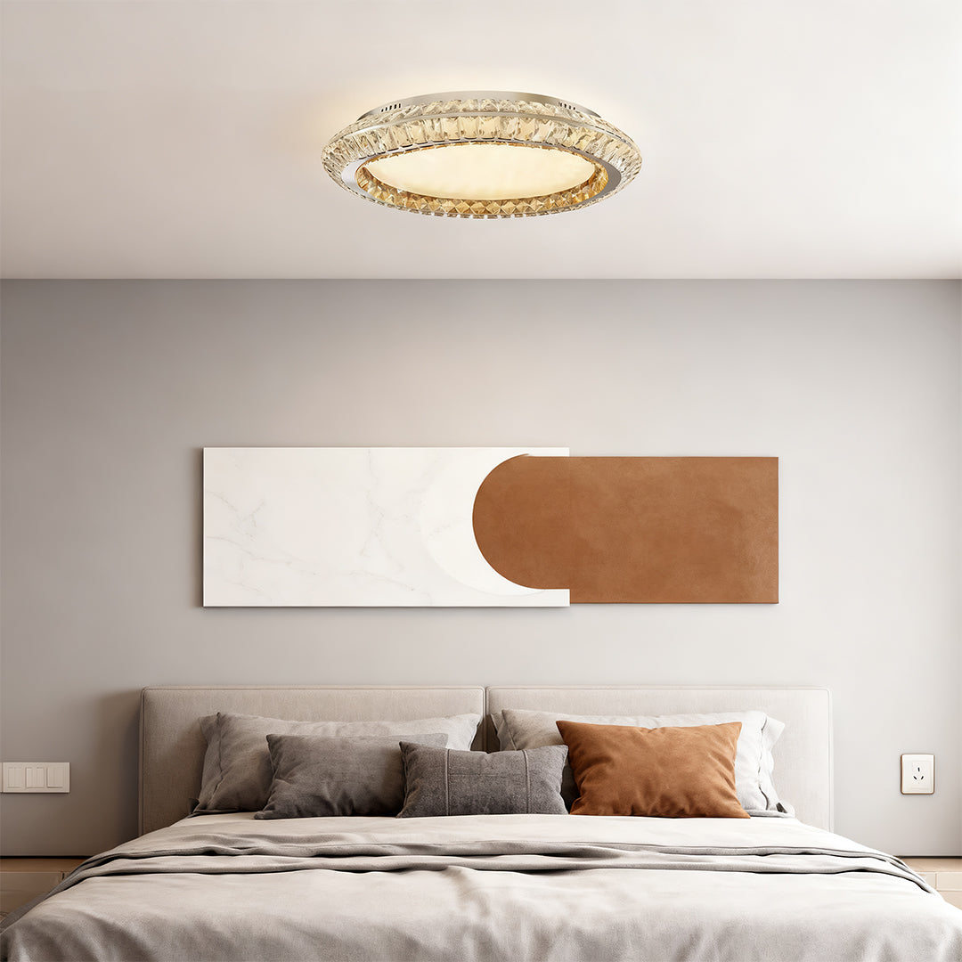 Flush mount crystal ceiling light installed above a bed, creating a cozy and elegant focal point.