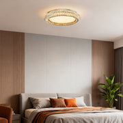 Flush mount crystal ceiling light in a minimalist bedroom, adding a touch of elegance to the space.