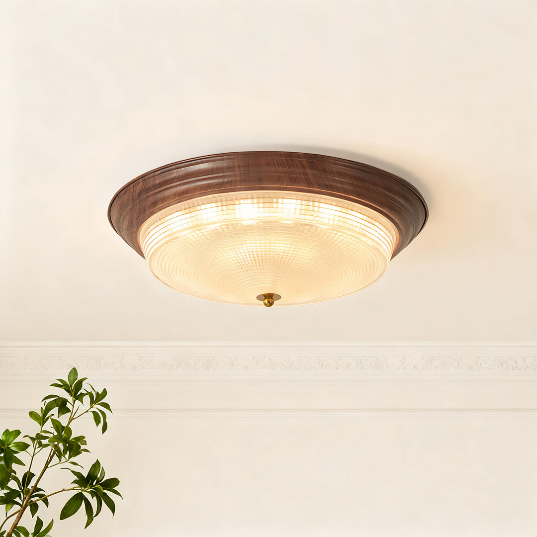 Flush mount dome light mounted in bright bedroom with arched window and neutral palette