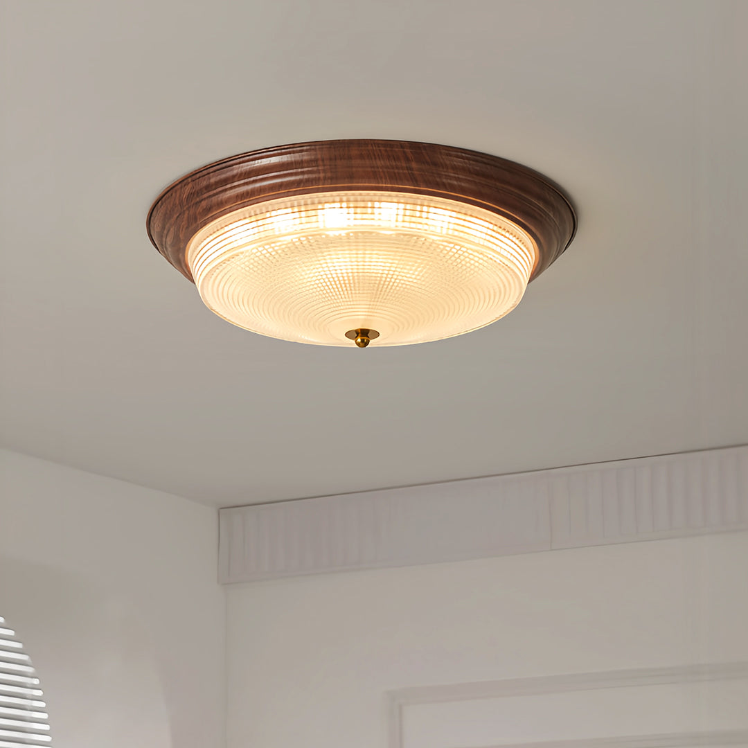 Flush mount dome light mounted in bright bedroom with arched window and neutral palette