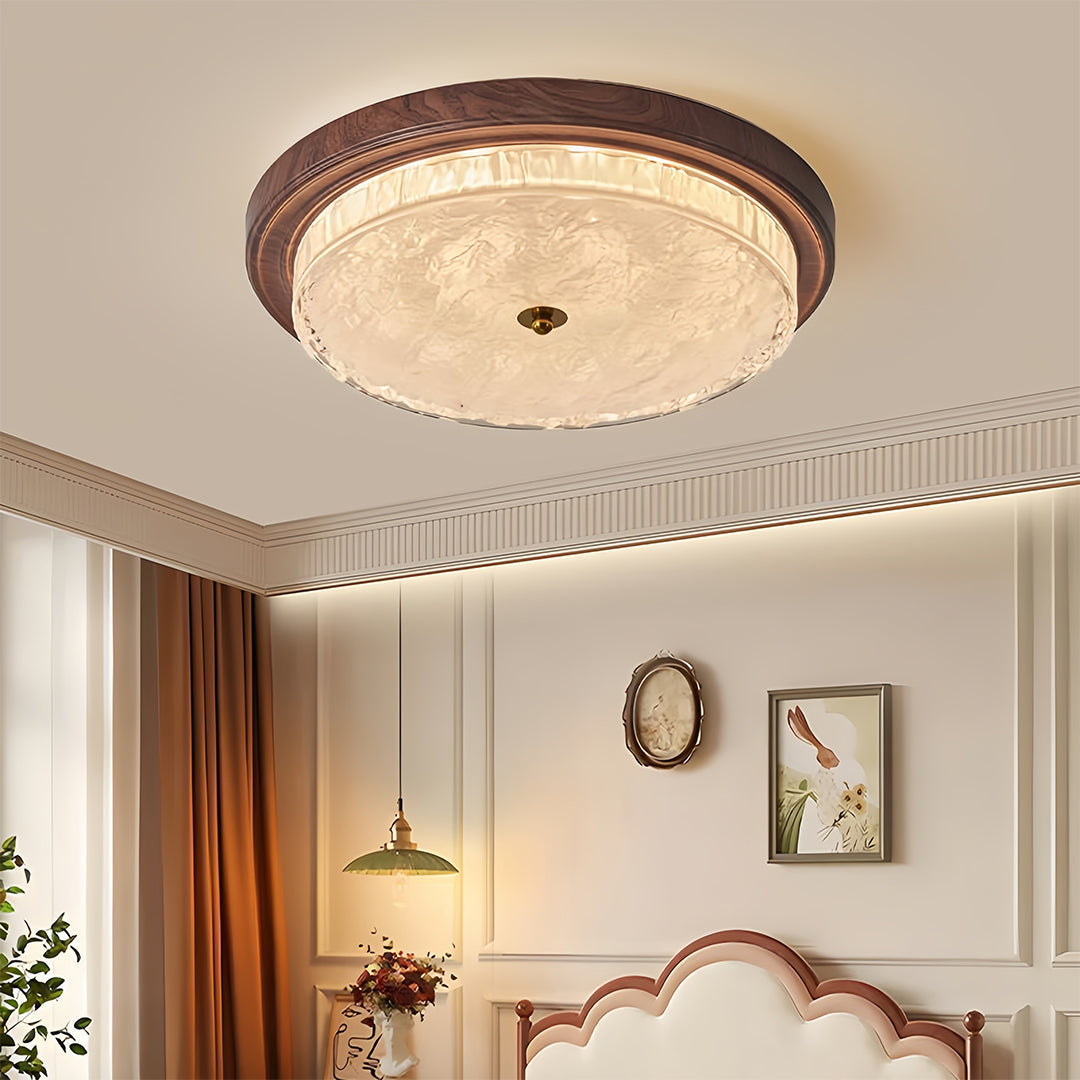 Flush mount dome light illuminating elegant bedroom with ornate headboard and neutral decor