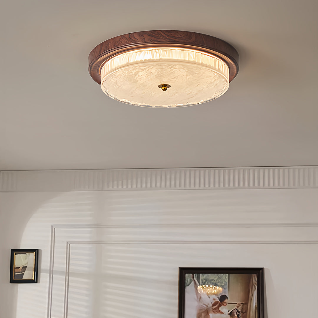Close-up detail of flush mount dome light highlighting bronze frame and glass texture