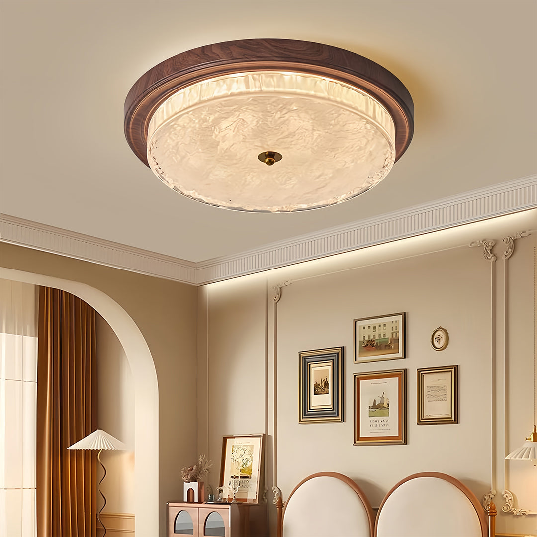 Close-up detail of flush mount dome light highlighting bronze frame and glass texture