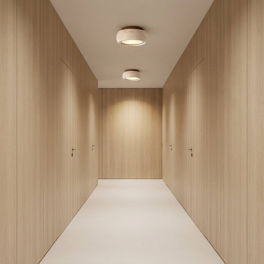 Flush mount entry light illuminating a minimalist hallway with soft warm light.
