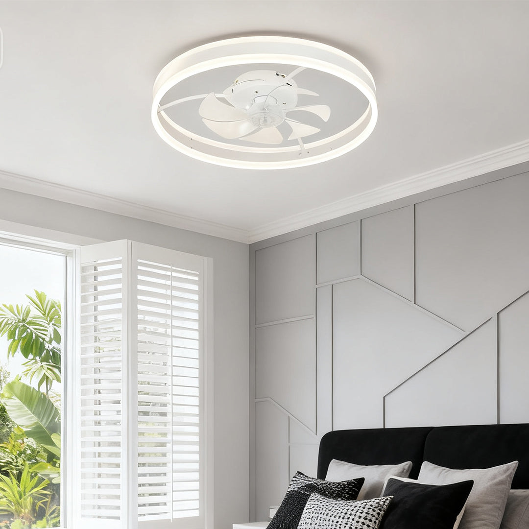 Flush mount modern white ceiling fan with light providing climate control in a stylish, gray paneled bedroom with ample natural light. 
