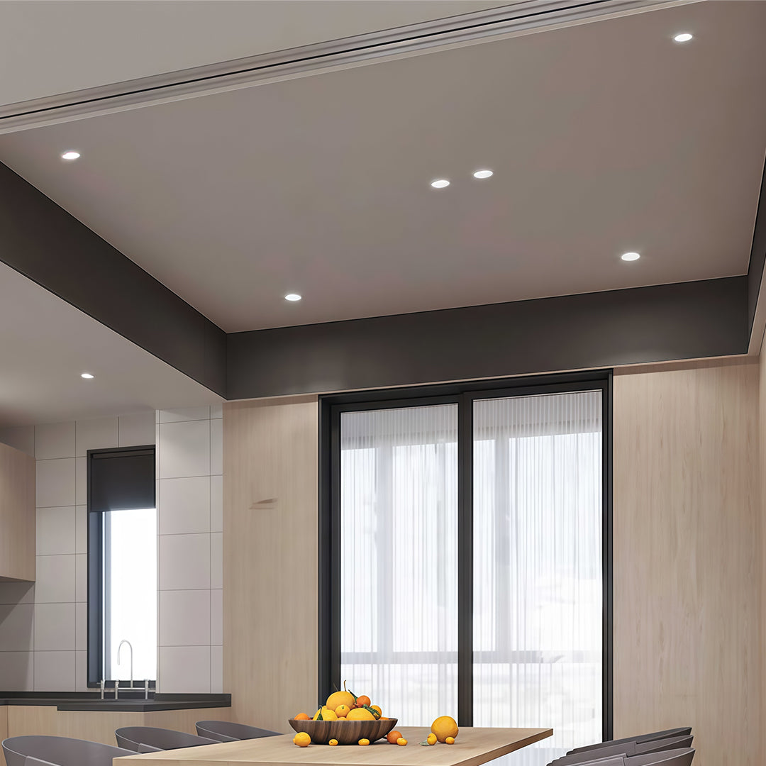 Flush mount spotlights enhancing contemporary dining space with large windows and neutral color palette