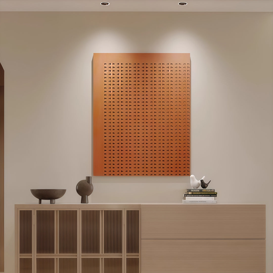 Flush mount spotlights accenting textured orange artwork above natural wood console with decorative objects