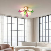 Colorful stained glass flush mount ceiling light installed in a bright living room with large windows and modern decor.