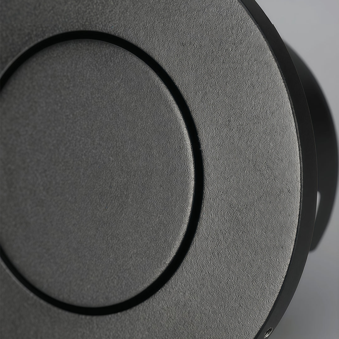 Detailed view of flush mount wall light with matte black circular frame and minimalist recessed lighting.