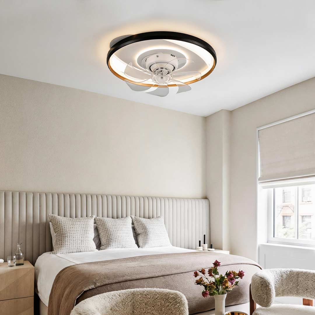 Flush mounted ceiling fan with light illuminating a modern bedroom with warm ambient glow.