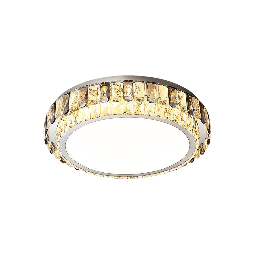 Round flush mounting LED light with crystal border and modern gold trim.