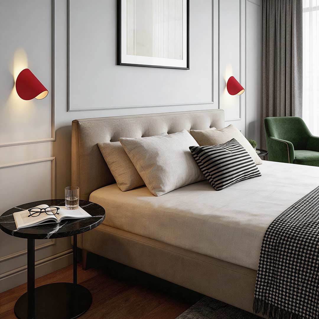 Folding wall sconce enhancing a contemporary bedside area with elegant directional light.