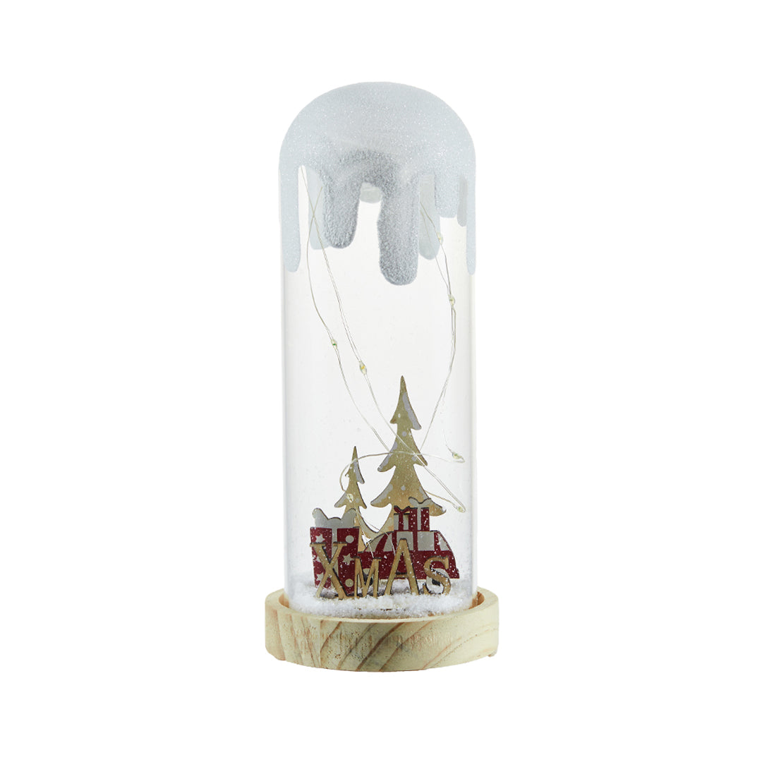 Miniature forest and cabin scene under frosted glass resembling a holiday white glass table lamp.