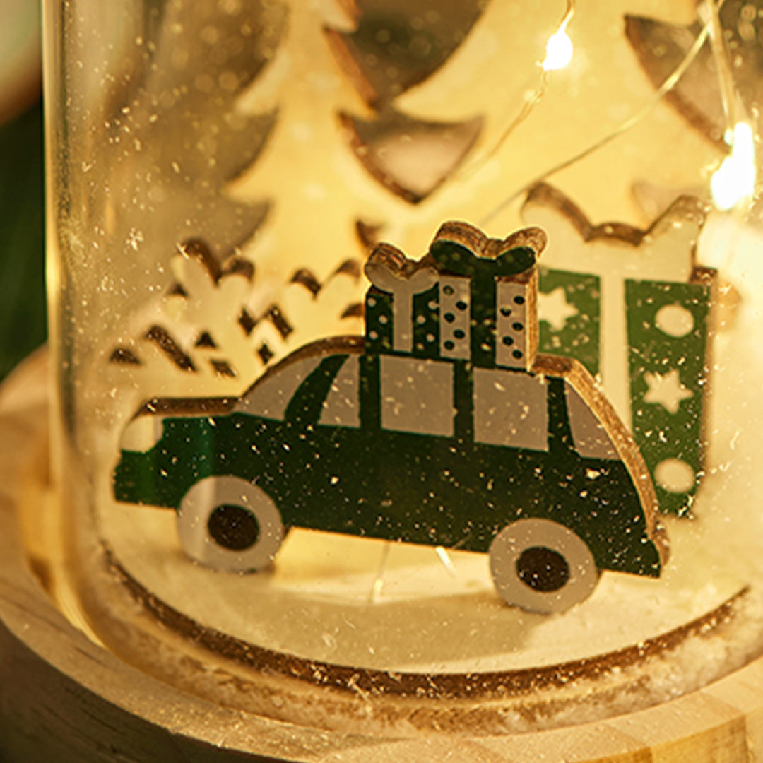 Snowy forest-themed dome lamp with glowing miniature car and tree, echoing the style of a white glass table lamp.