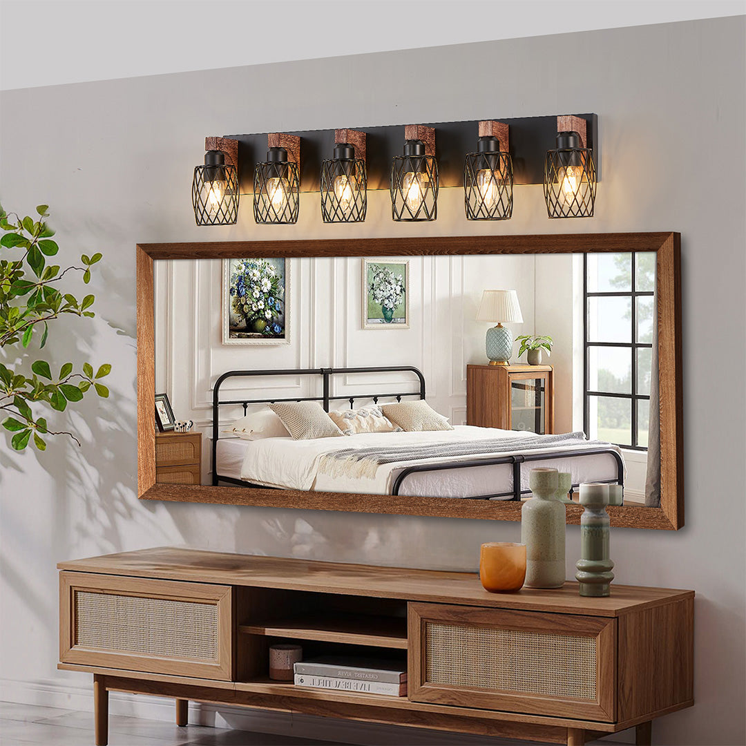 Black vanity bathroom light with four bulbs, providing bright and even lighting above a bathroom mirror.