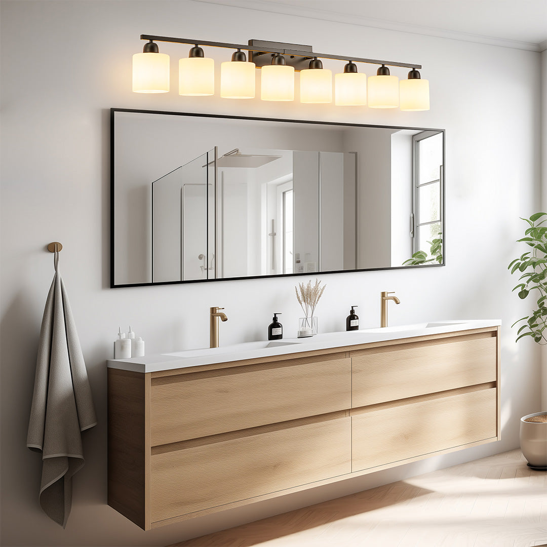Modern bathroom vanity light with four bulbs, providing bright illumination above a double sink vanity.