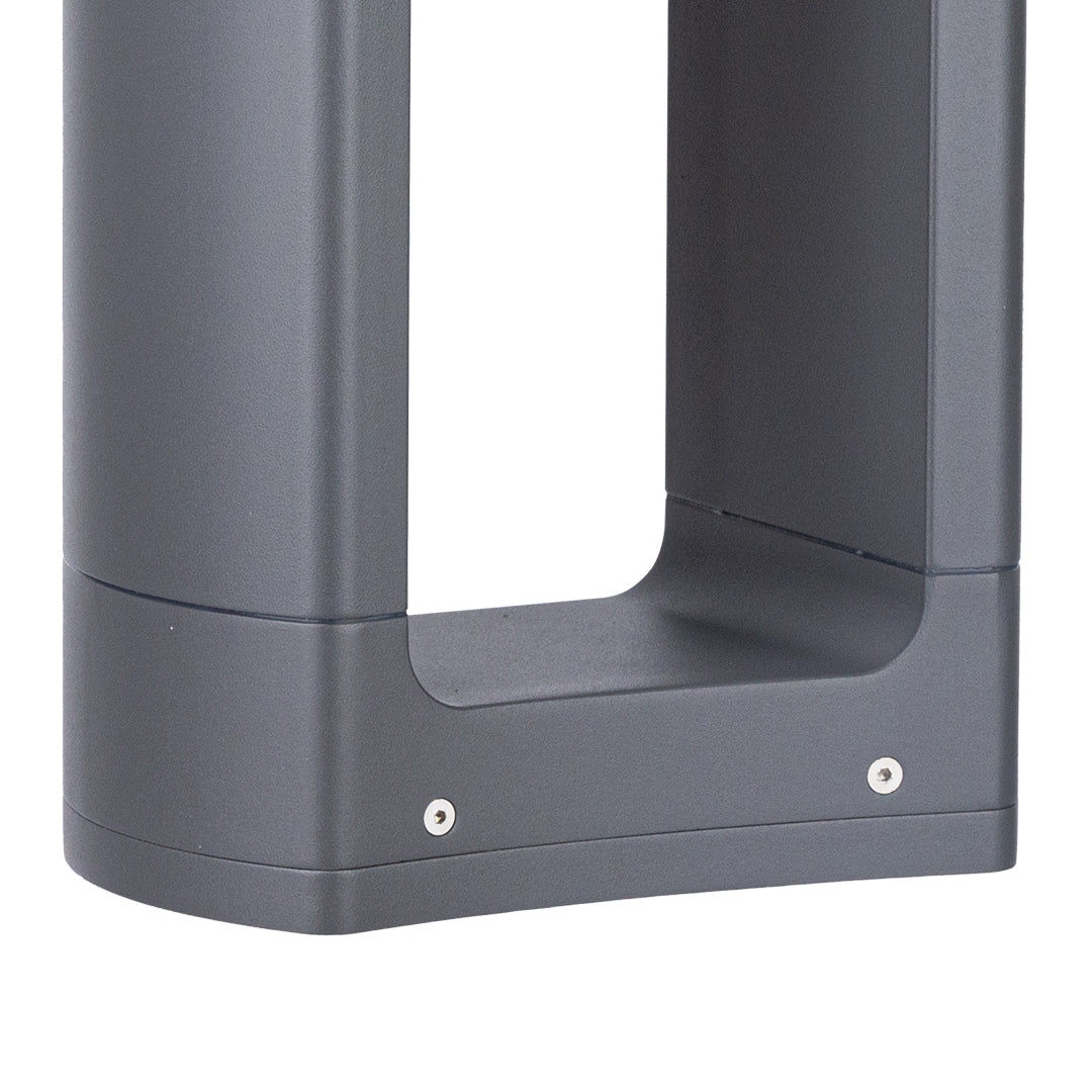 Modern frame-style bollard light creating dramatic accent lighting on lawn area