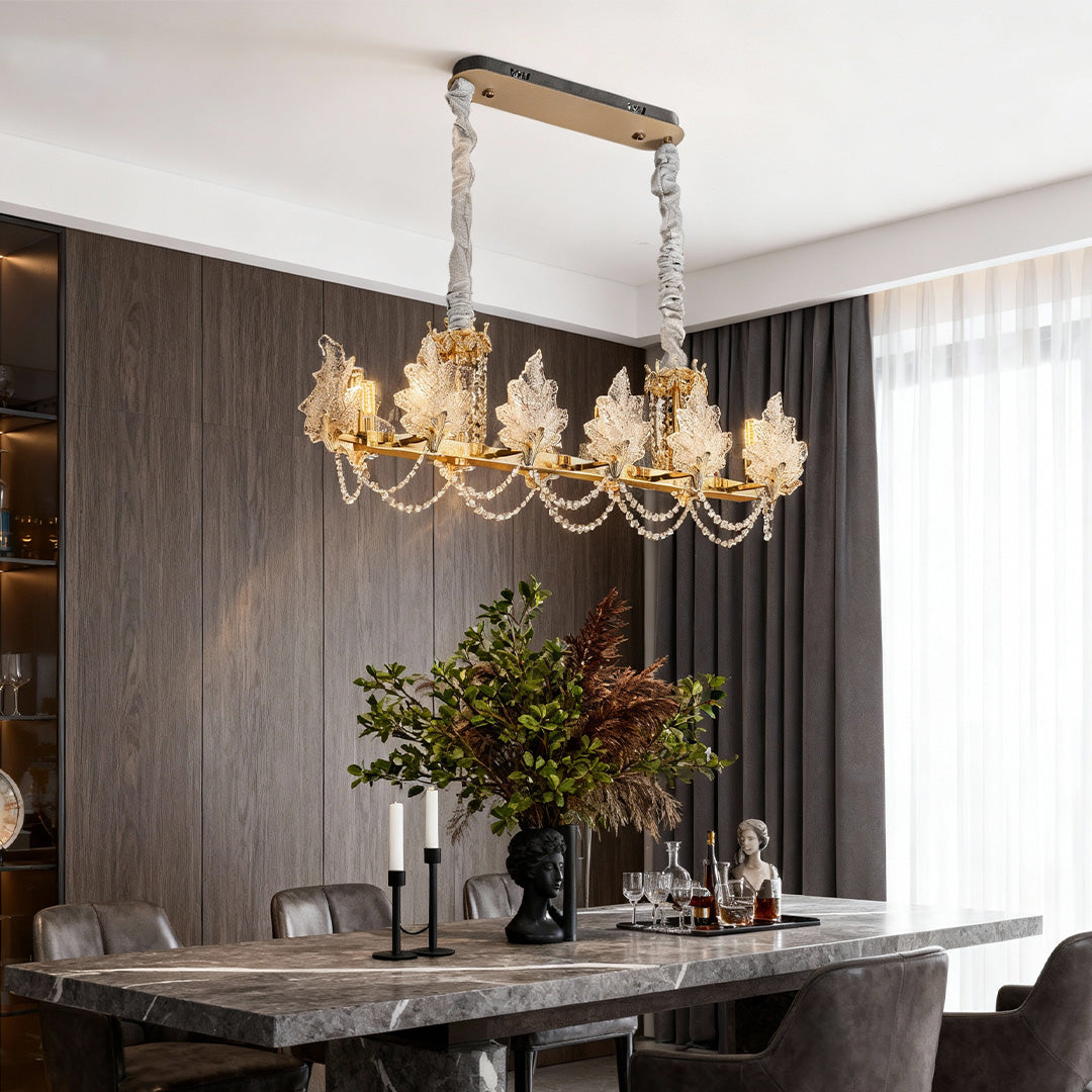 French crystal chandelier illuminating a modern dining table setting.