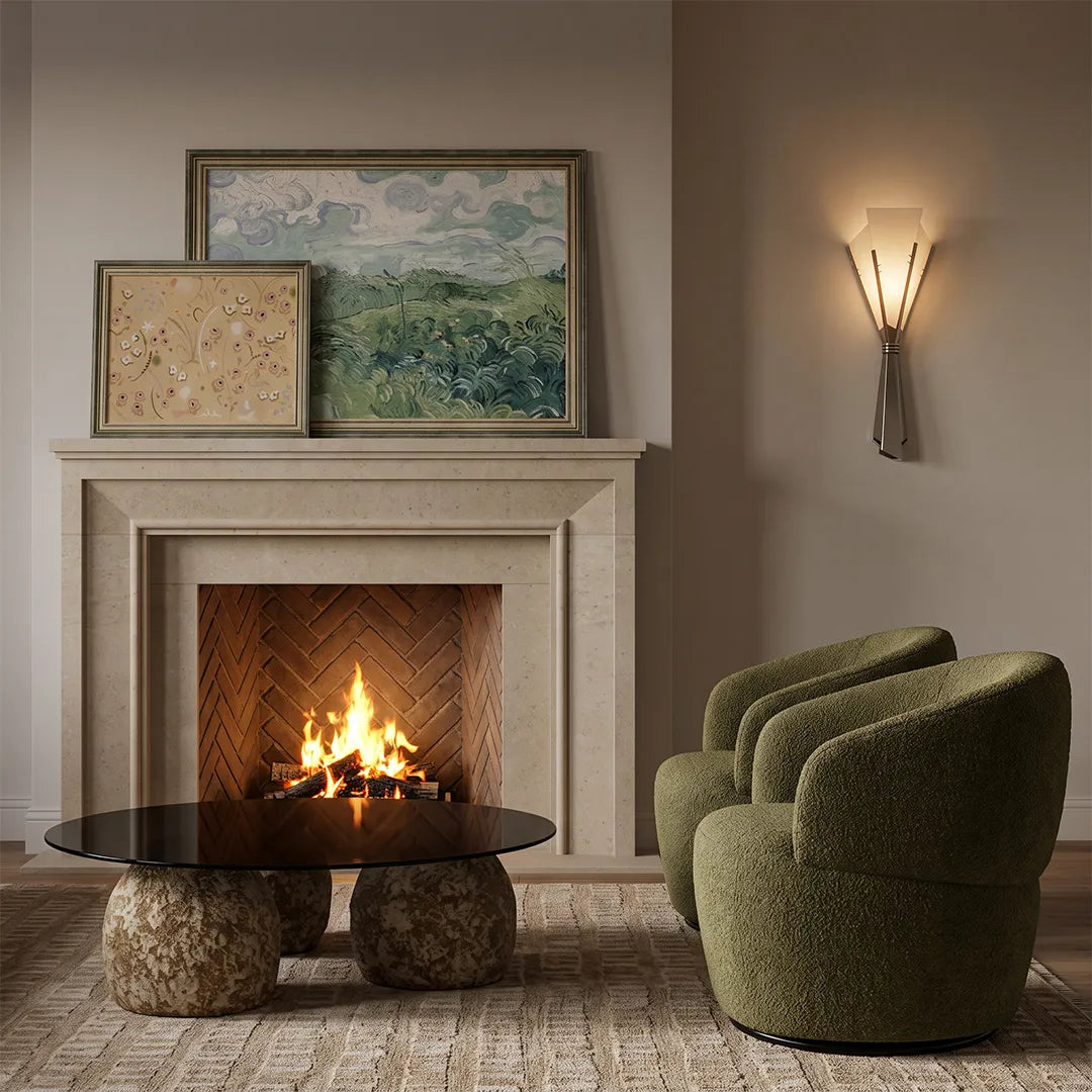 French wall sconces mounted beside a fireplace in a living room with soft ambient lighting.