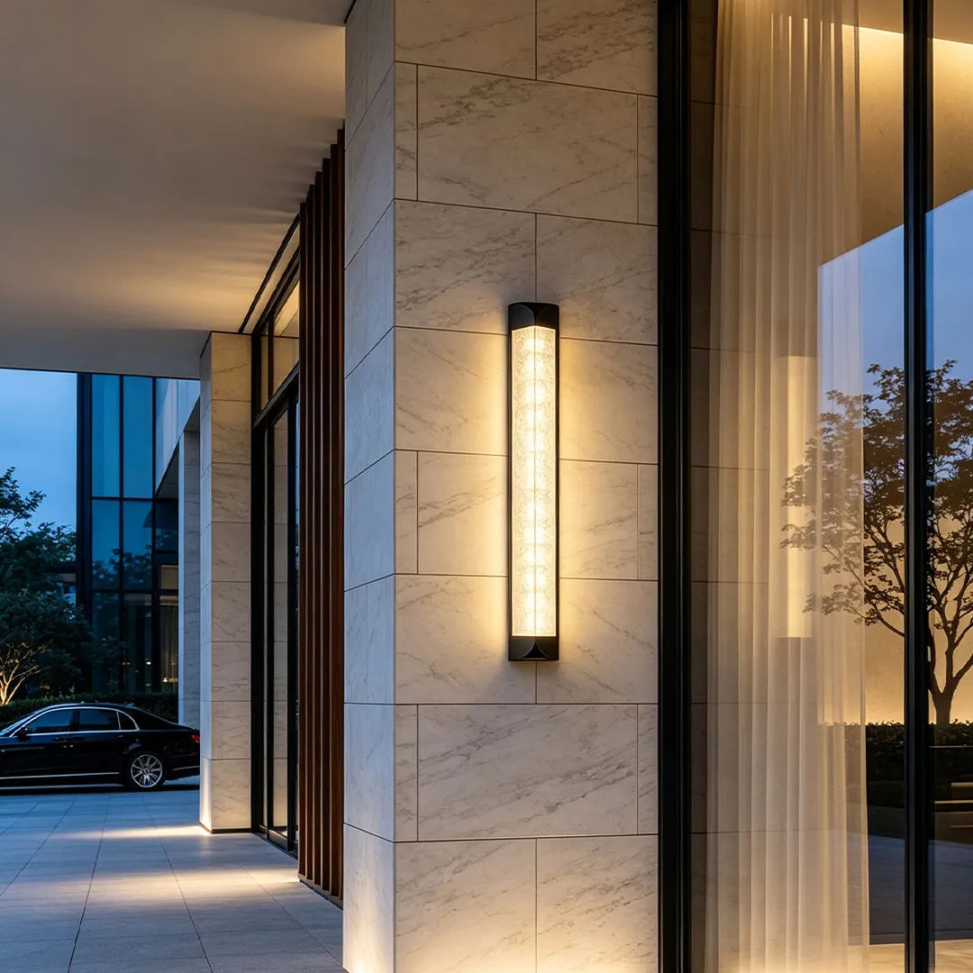 Wall sconce outdoor mounted beside a front door creating elegant exterior lighting.