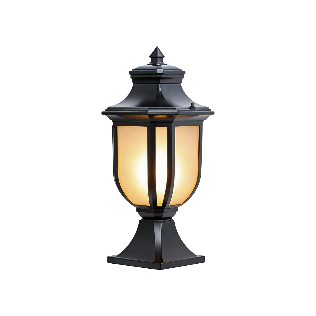 Frontal view of a black vintage outdoor pillar lantern with glowing glass on white background.