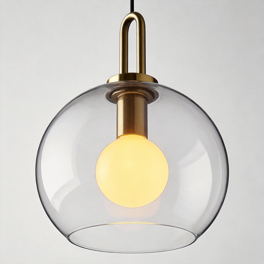 Frosted glass mini pendant light in gold, close-up of the bulb and glass detail.