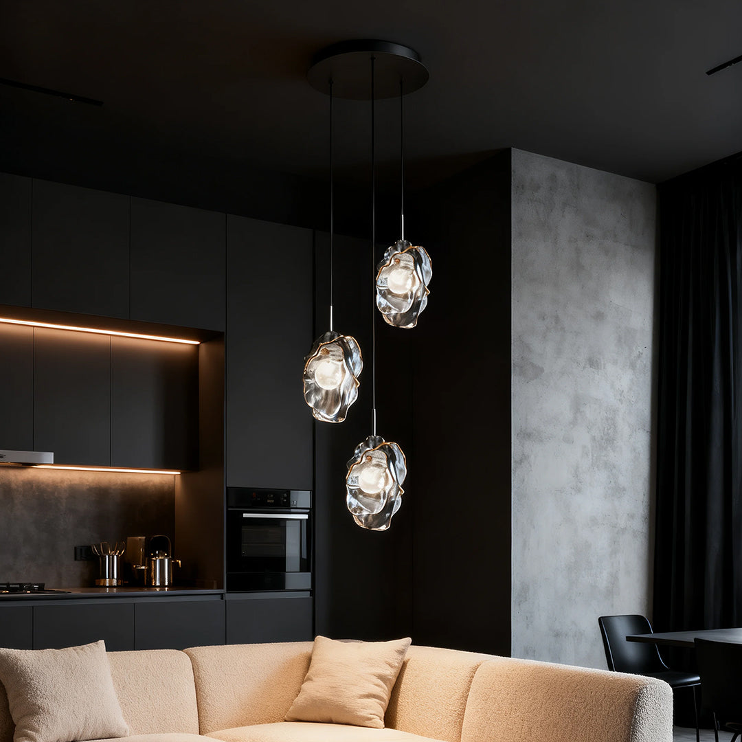 Fun pendant lights creating ambient glow in dark contemporary living space with tan sofa