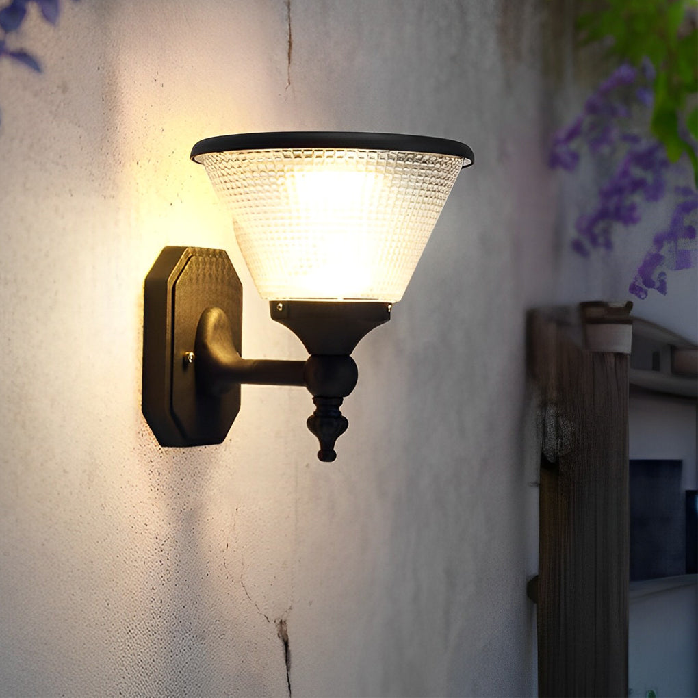 Funnel wall light with warm LED bulb mounted on a textured wall, enhancing outdoor ambiance.