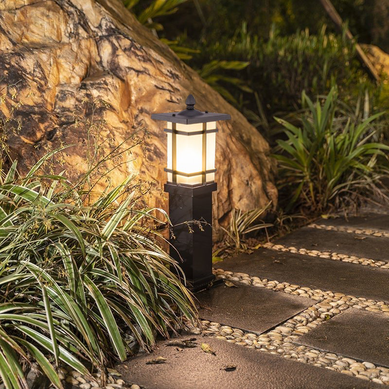 Garden bollard lighting with a close-up of its illuminated lantern-style top.