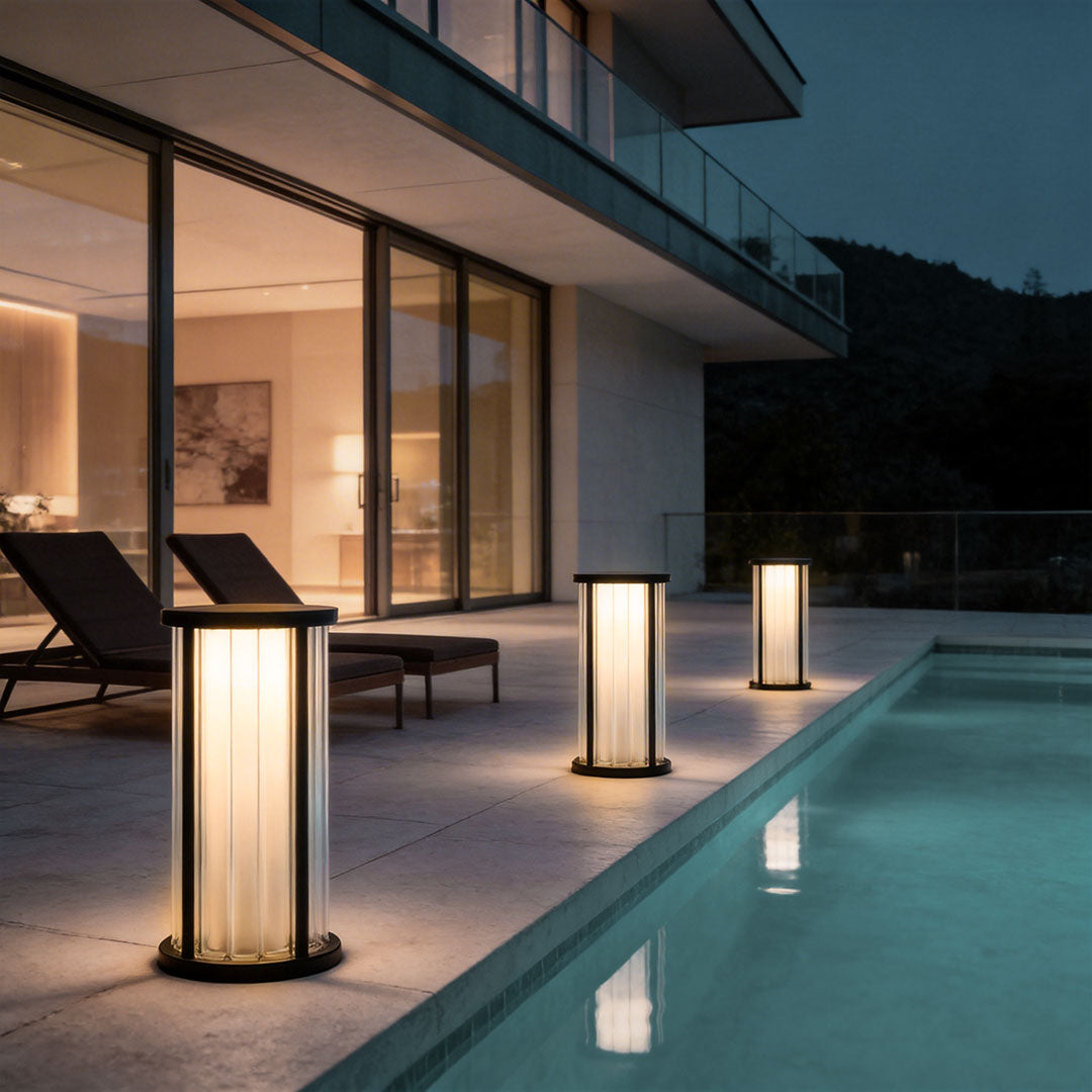 Garden bollard lighting with a contemporary design, enhancing a modern house exterior.