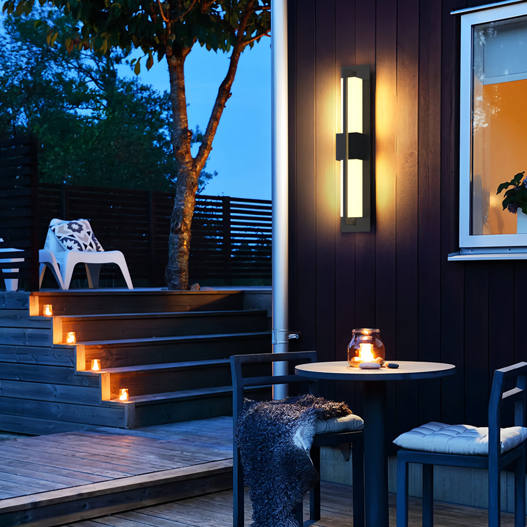 Stylish garden bollard lighting fixtures brightening an evening patio lounge area with soft warm light.