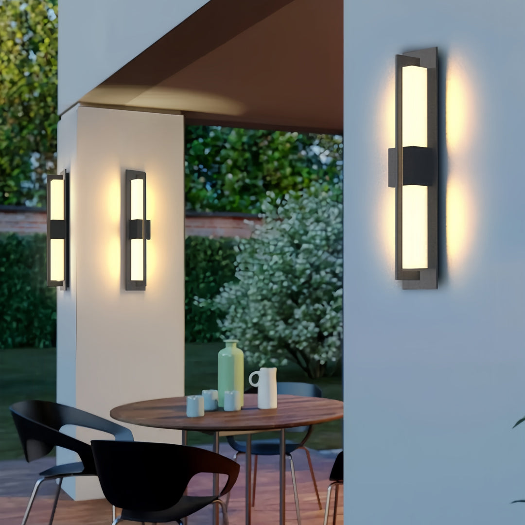 Vertical garden bollard lighting fixture mounted near a modern porch, creating a clean architectural accent glow.