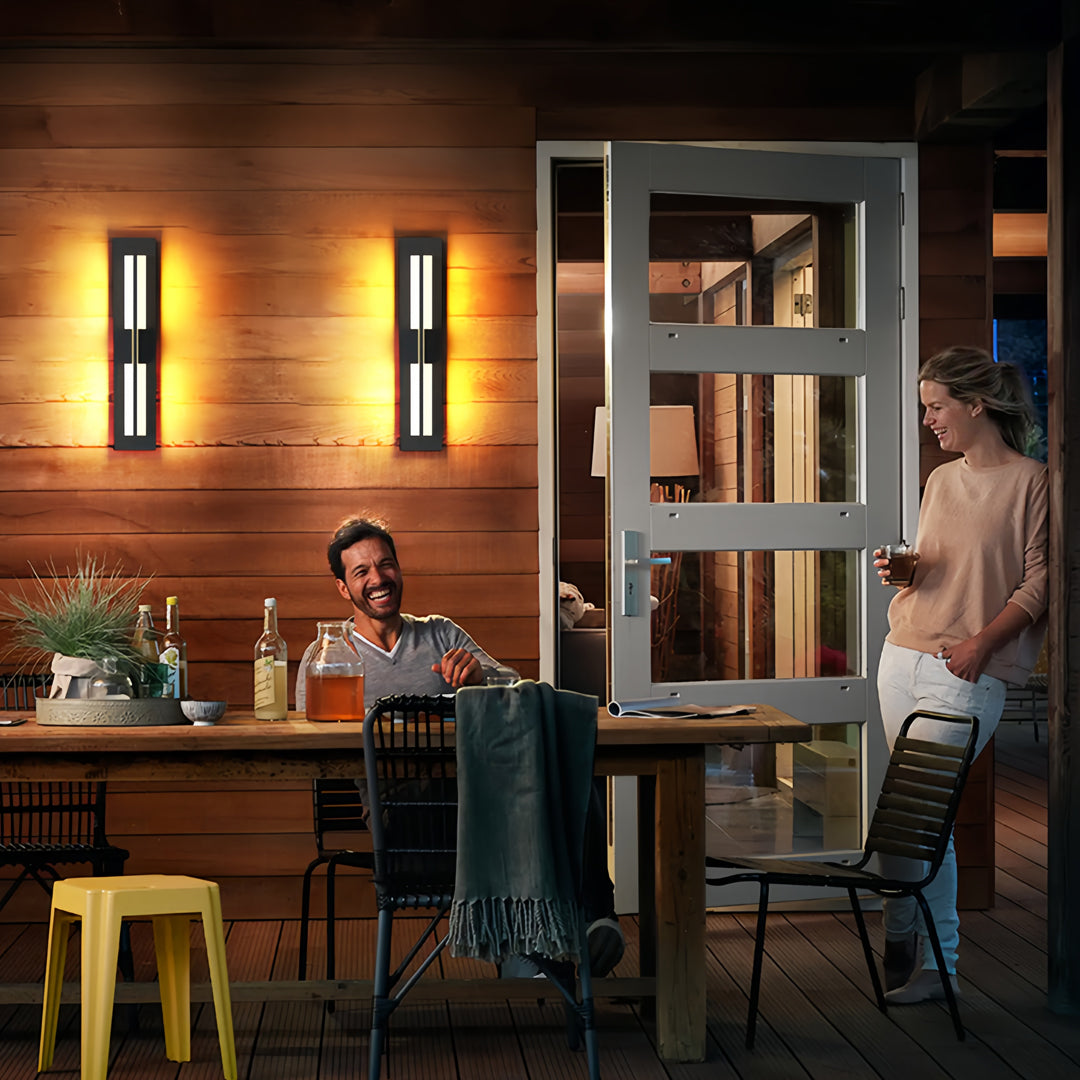 Ambient garden bollard lighting adding warm illumination to a lively outdoor dining and social gathering space.