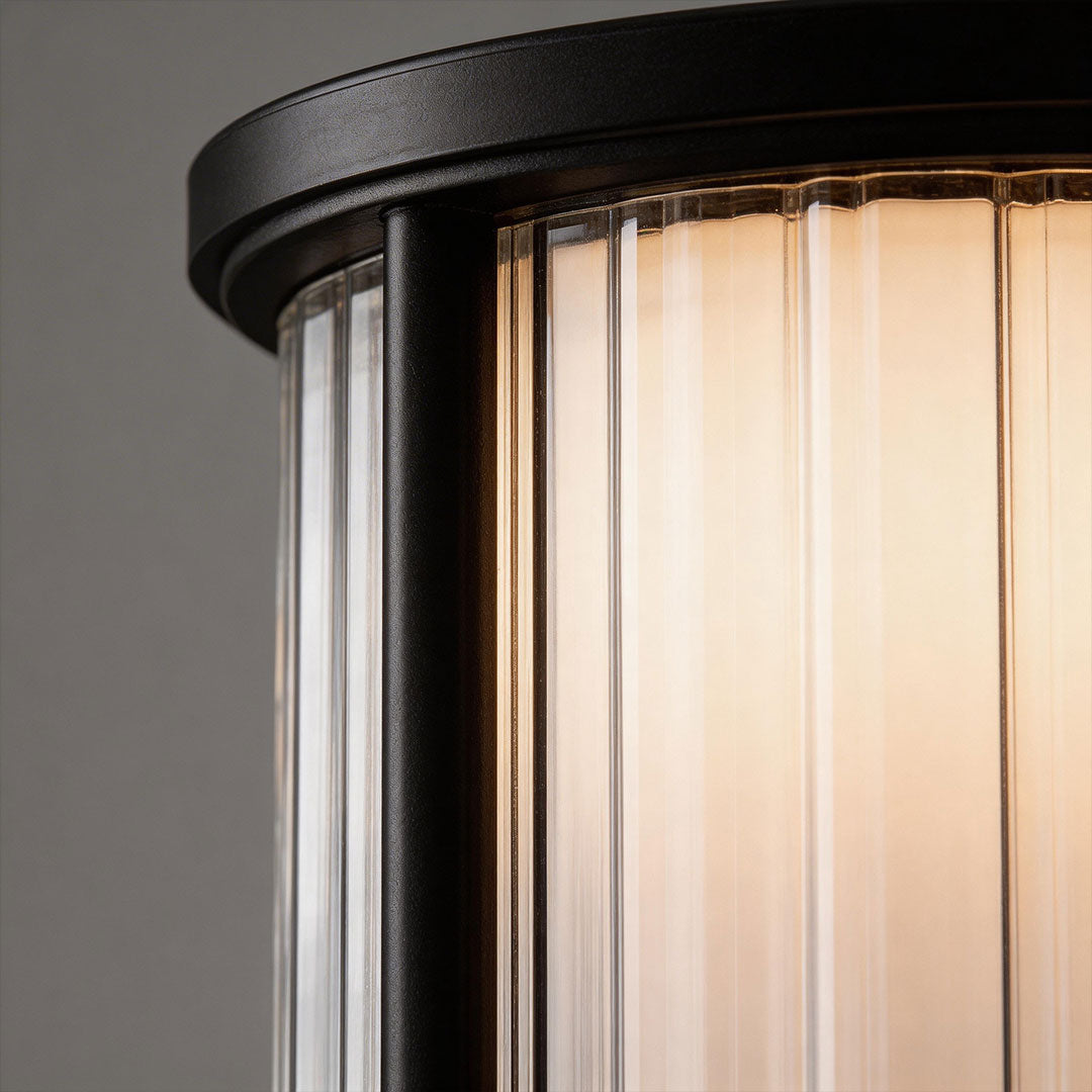 Garden bollard lighting with a sleek design, providing ambient lighting near a pool.