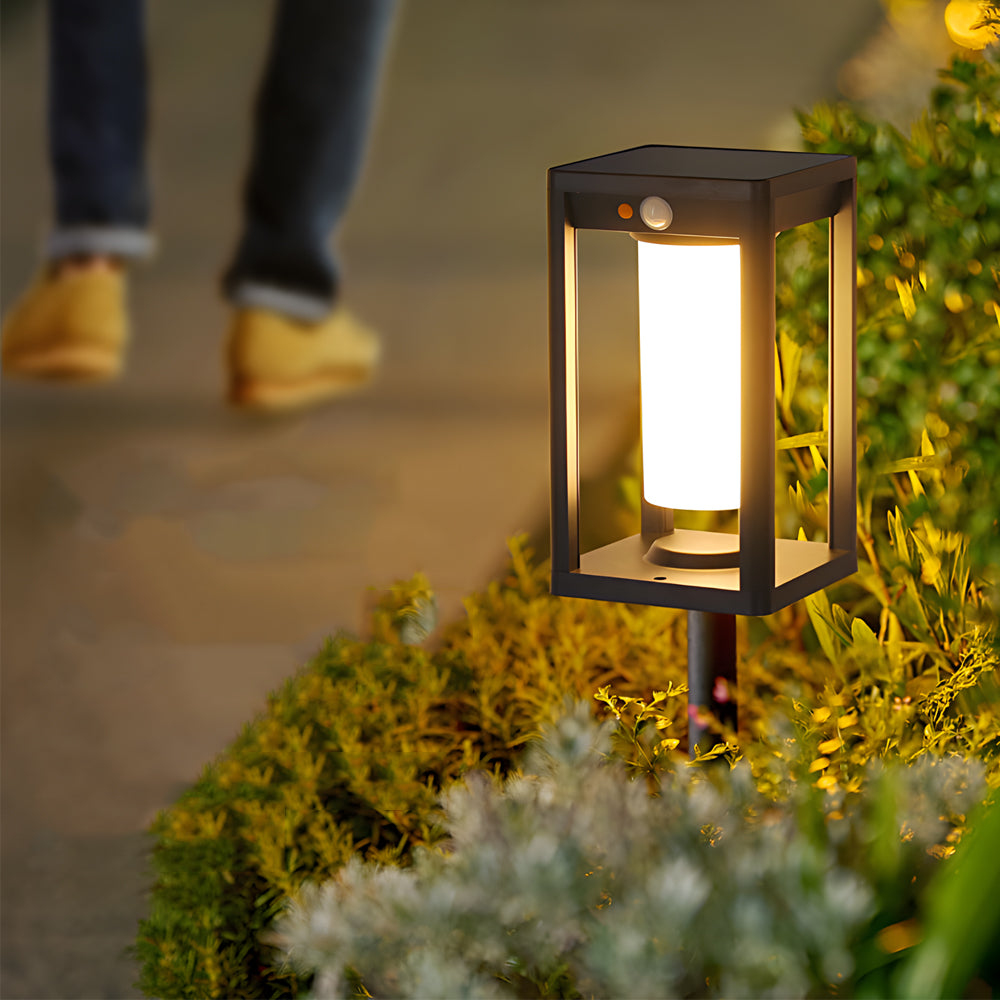 Garden border enhanced with glowing cage-style lights providing subtle accent illumination among plants