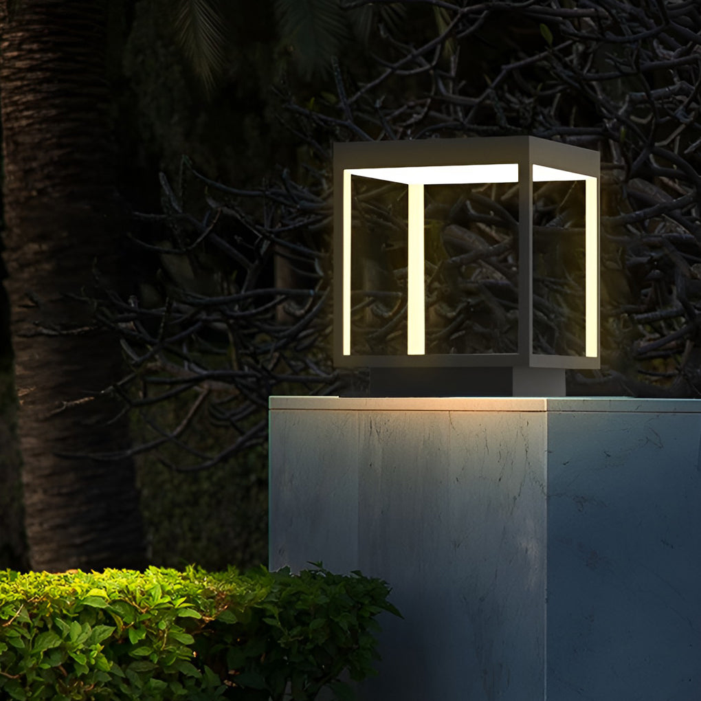 Concrete pillar lights illuminating a garden landscape at night.