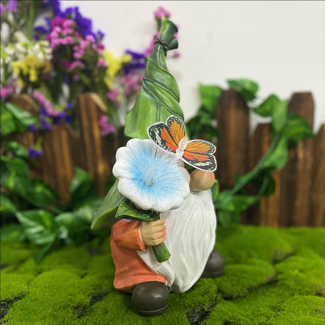 Garden gnome with butterfly and glowing flower creating magical lighting effect outdoors