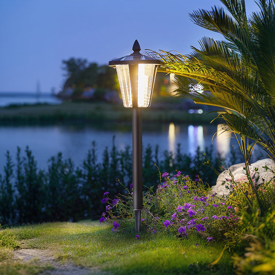 Contemporary outdoor lighting installed in landscaped garden setting with colorful flowers and plants