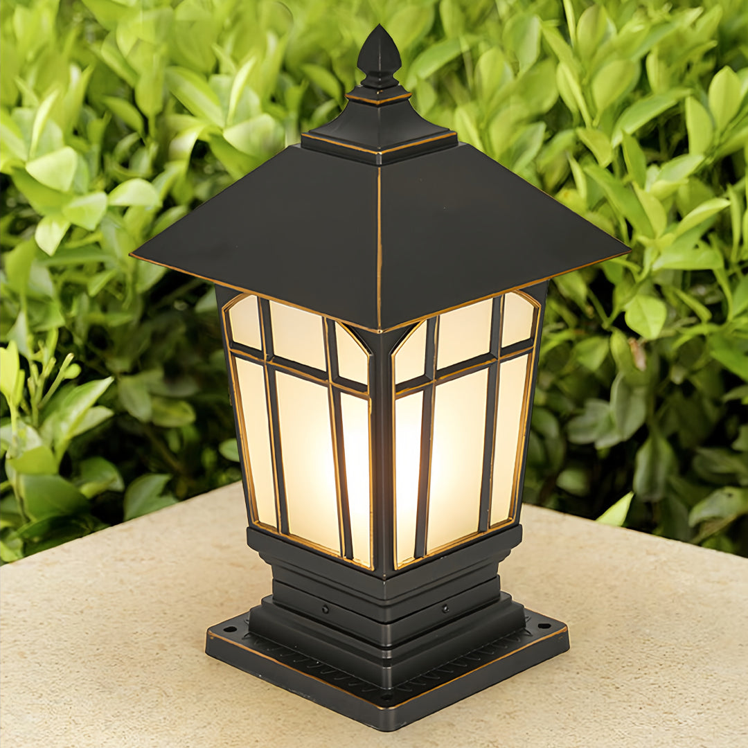 Large outdoor pillar lights displayed in a garden scene with warm nighttime glow.