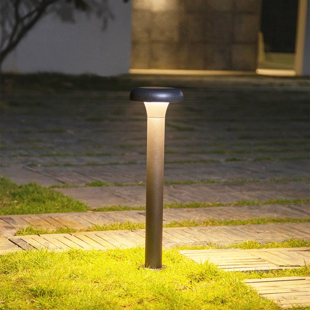 Garden led lights installed along stone pavers, delivering even ground illumination for a clean and modern outdoor garden design.