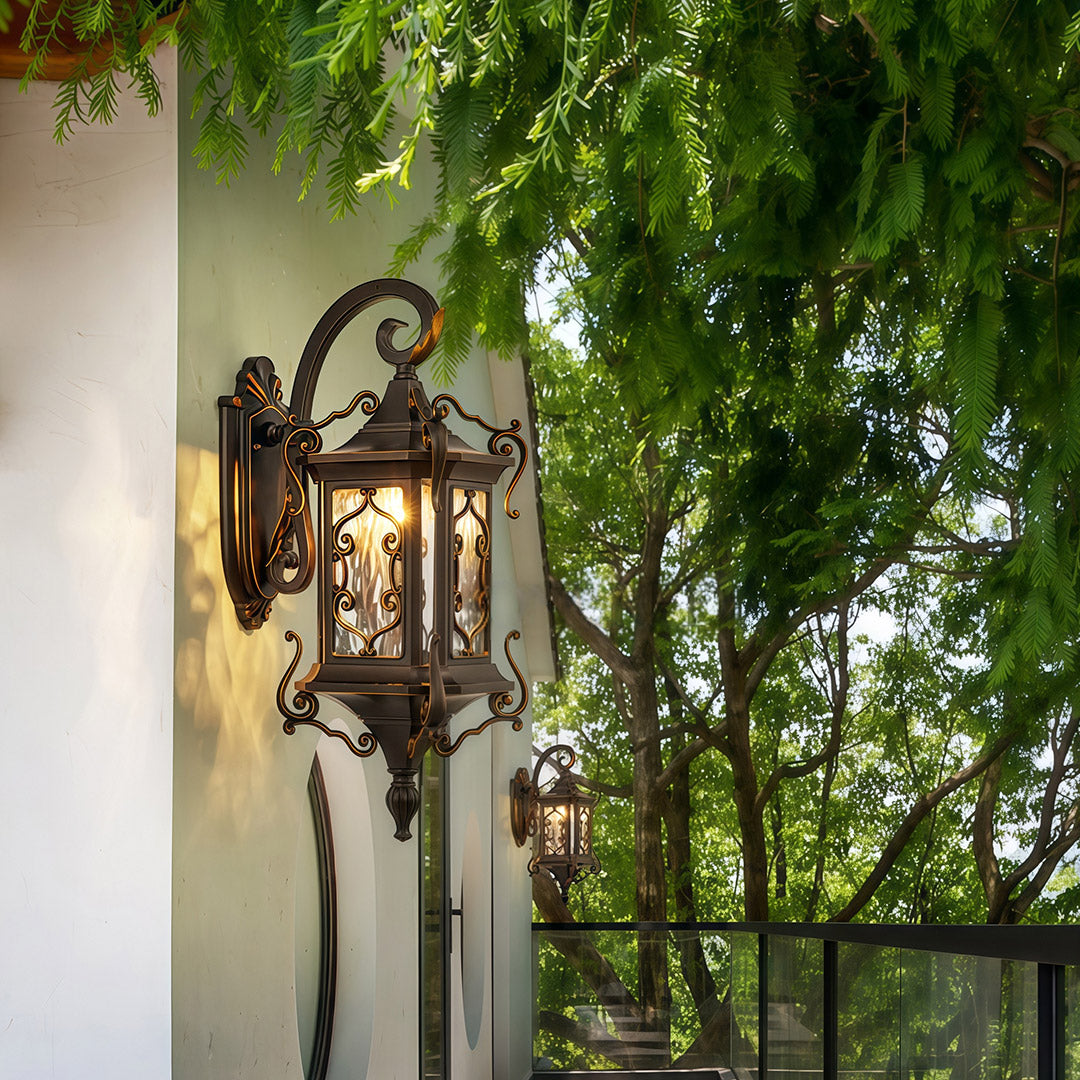 Outdoor Wall Sconce Light mounted on exterior wall under garden greenery.