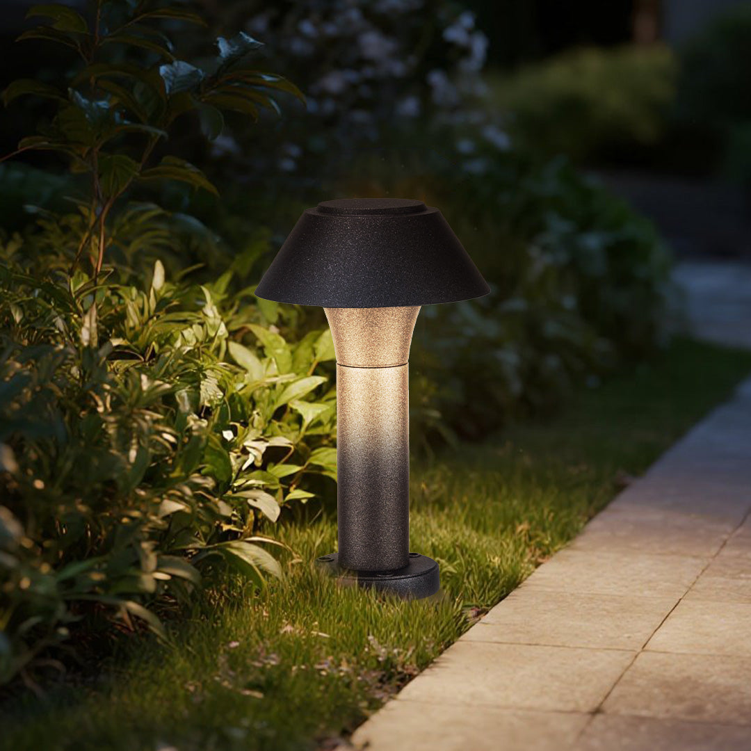 Evening garden scene with mushroom bollard lights illuminating stone pathway and landscaping