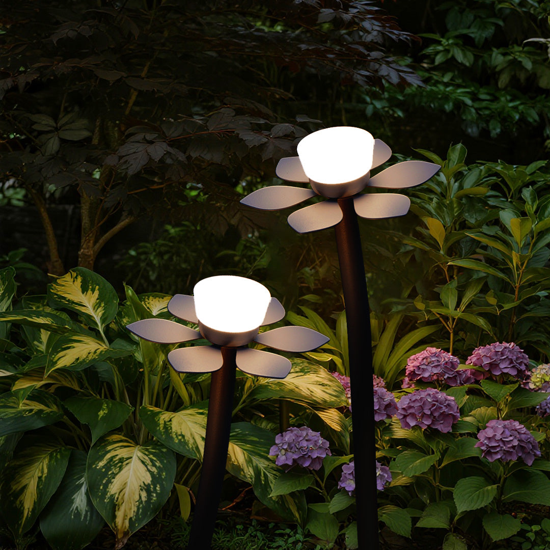 Garden outdoor landscape lights LED installation with flower-shaped fixtures illuminating colorful flowering plants and foliage