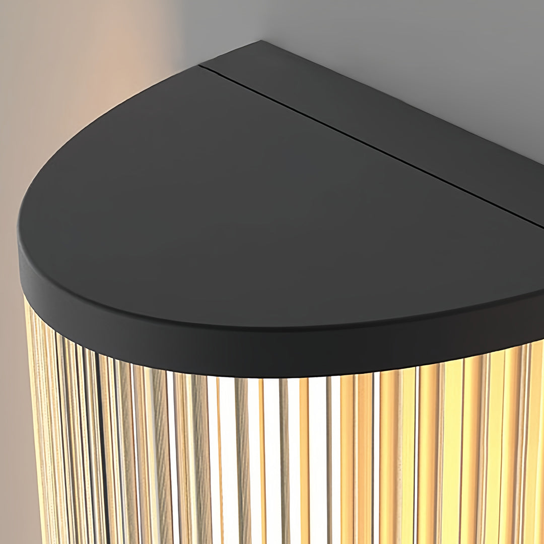 Landscaped garden path featuring vertical wall sconce lighting fixtures mounted on exterior walls for ambiance.