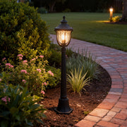 Bollard post light along a garden pathway, stylish and warm outdoor lighting solution