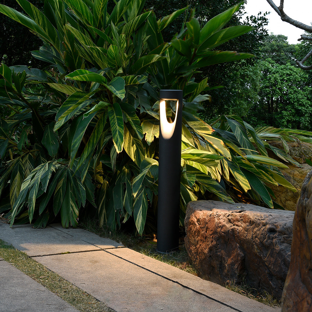 Garden pathway lighting installation featuring multiple bollards creating warm ambient glow