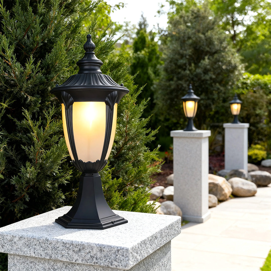 Exterior pillar light along a garden pathway, stylish and warm outdoor lighting solution