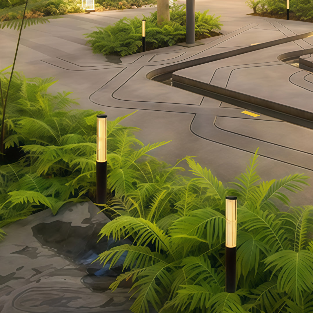 Modern garden pathway illuminated by led bollard garden lights casting soft warm light across curved walkway.