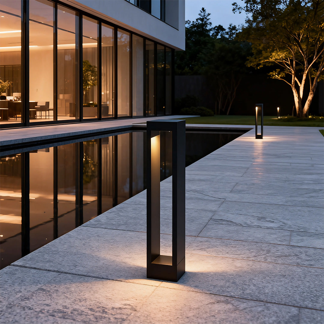 Garden pathway light placed near a garden bed, enhancing the outdoor ambiance with subtle lighting.