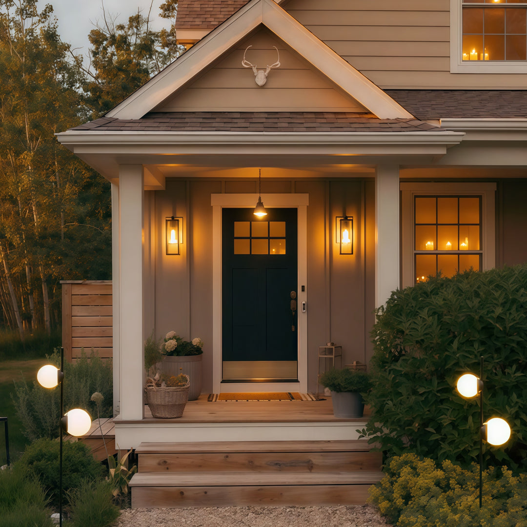Warm decorative post lights framing a home entrance, providing welcoming and ambient garden pathway lighting along the front walkway.